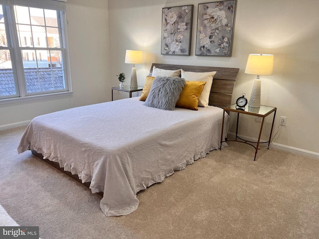 bedroom featuring baseboards and carpet floors