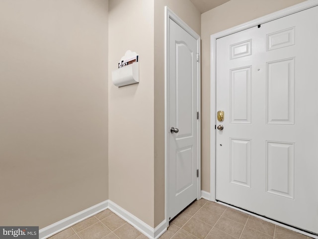 interior space with light tile patterned floors and baseboards