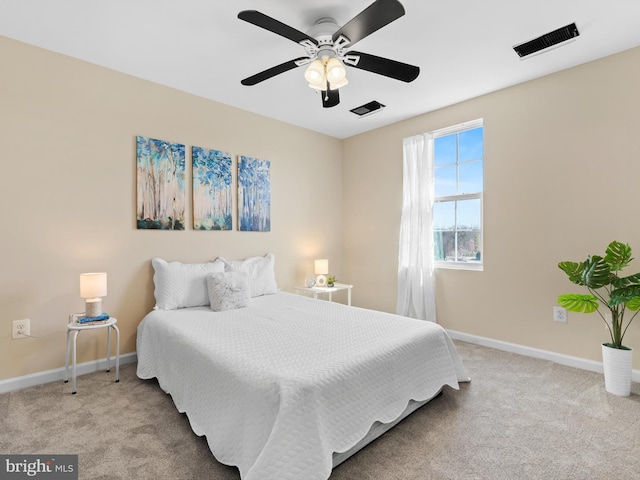 carpeted bedroom featuring visible vents, a ceiling fan, and baseboards