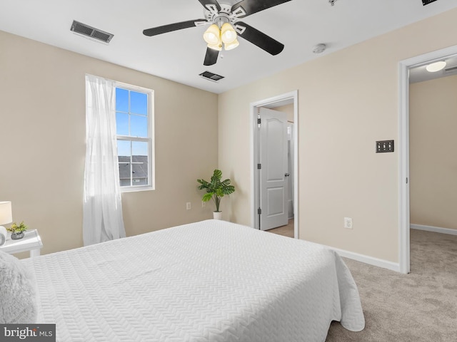 bedroom featuring visible vents, light carpet, baseboards, and a ceiling fan