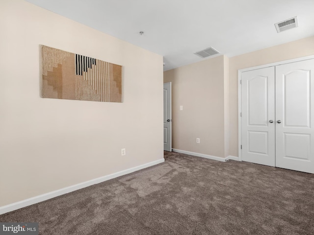 unfurnished bedroom with a closet, baseboards, visible vents, and carpet floors