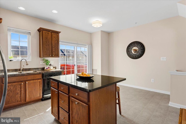 kitchen with a sink, a wealth of natural light, black dishwasher, and a breakfast bar area