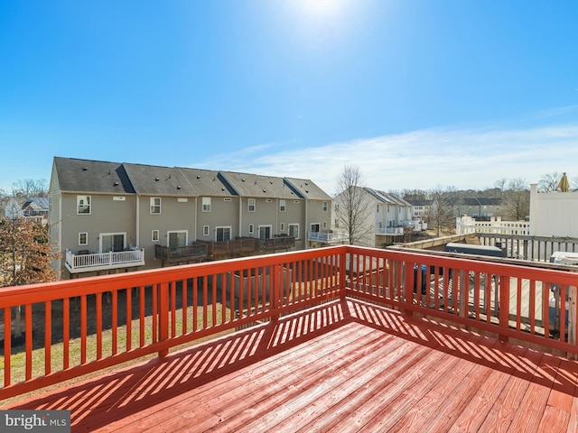 deck featuring a residential view and a fenced backyard