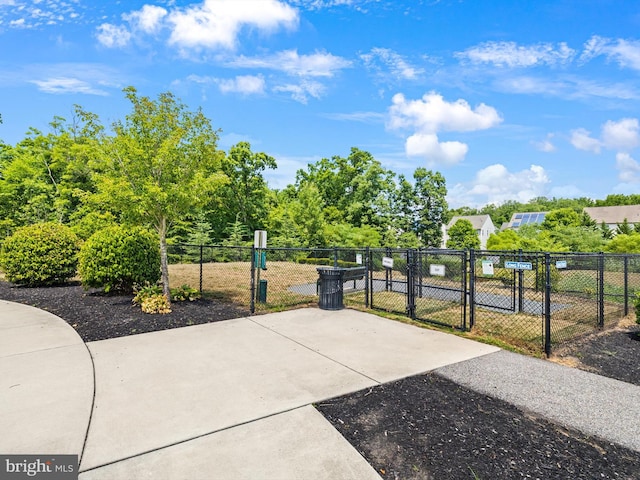 view of home's community featuring a gate and fence