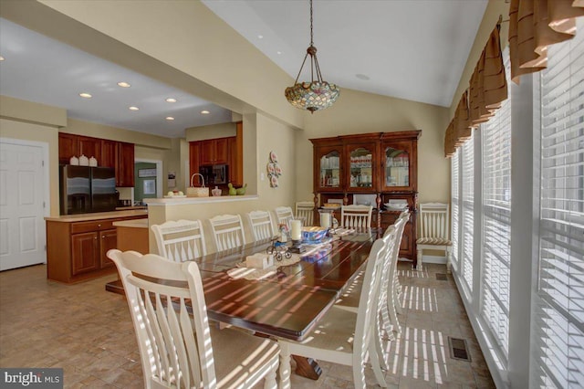 dining space with visible vents, recessed lighting, and vaulted ceiling