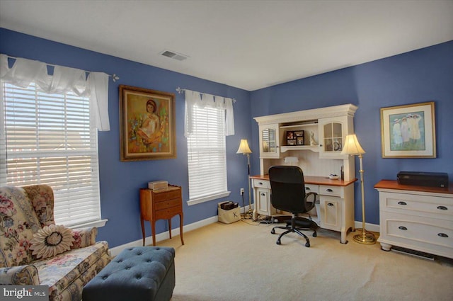 carpeted office featuring visible vents and baseboards