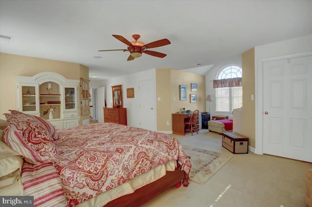 bedroom featuring visible vents, light carpet, baseboards, ceiling fan, and vaulted ceiling