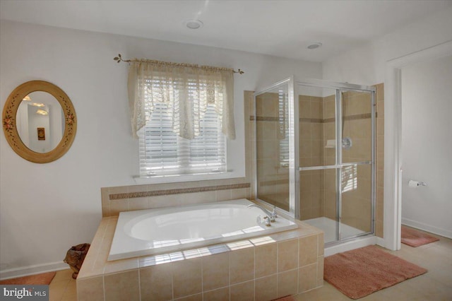 full bathroom with a shower stall and a garden tub