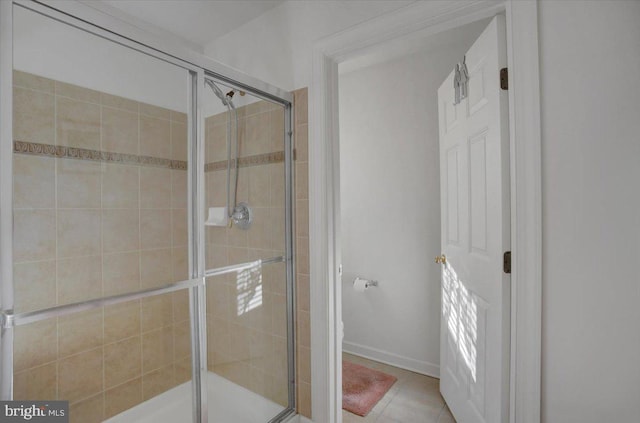 full bathroom featuring tile patterned flooring, a shower stall, and toilet