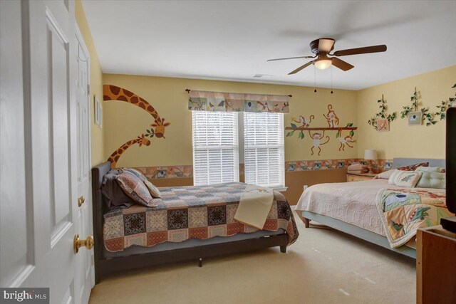 carpeted bedroom featuring visible vents and ceiling fan