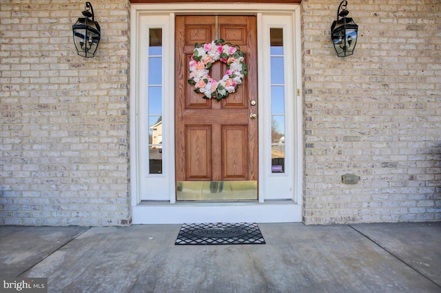 view of exterior entry with brick siding