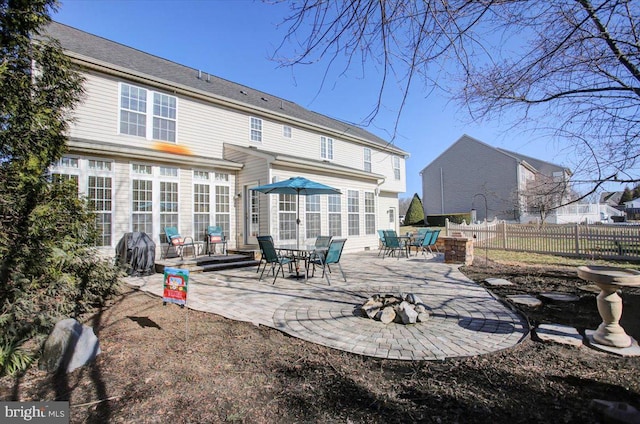 rear view of property with a patio area, fence, and a fire pit