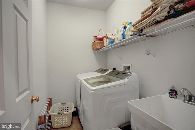 washroom with washer and dryer, laundry area, and a sink