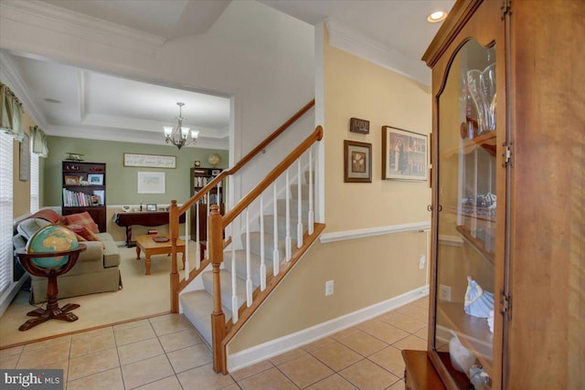 stairway featuring an inviting chandelier, tile patterned floors, and ornamental molding