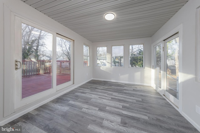 unfurnished sunroom featuring wood ceiling