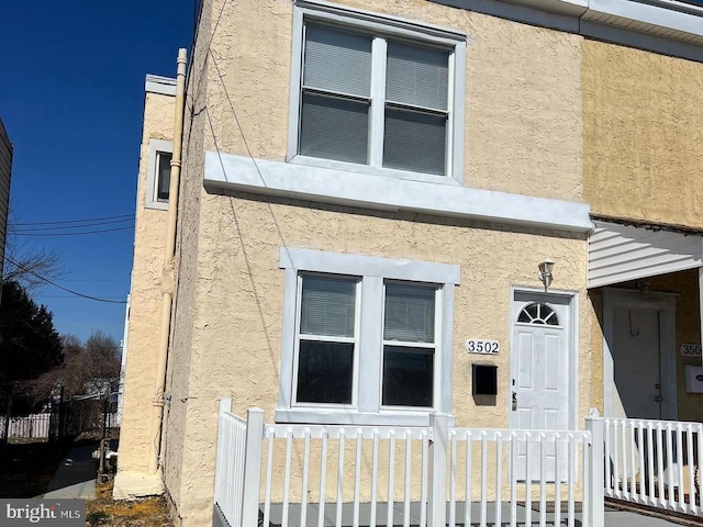 view of home's exterior featuring a fenced front yard and stucco siding