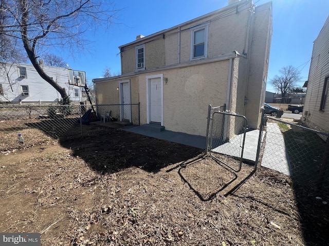 back of house with fence and stucco siding