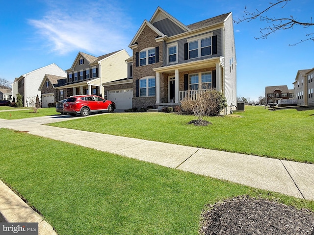 view of front of house featuring a front lawn, an attached garage, brick siding, and a residential view