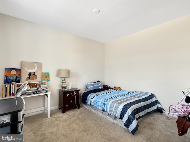 bedroom with baseboards and carpet