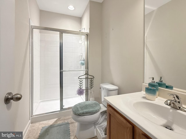 full bath featuring vanity, a shower stall, and toilet