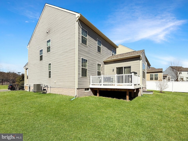 rear view of house featuring a yard, central AC, a deck, and fence