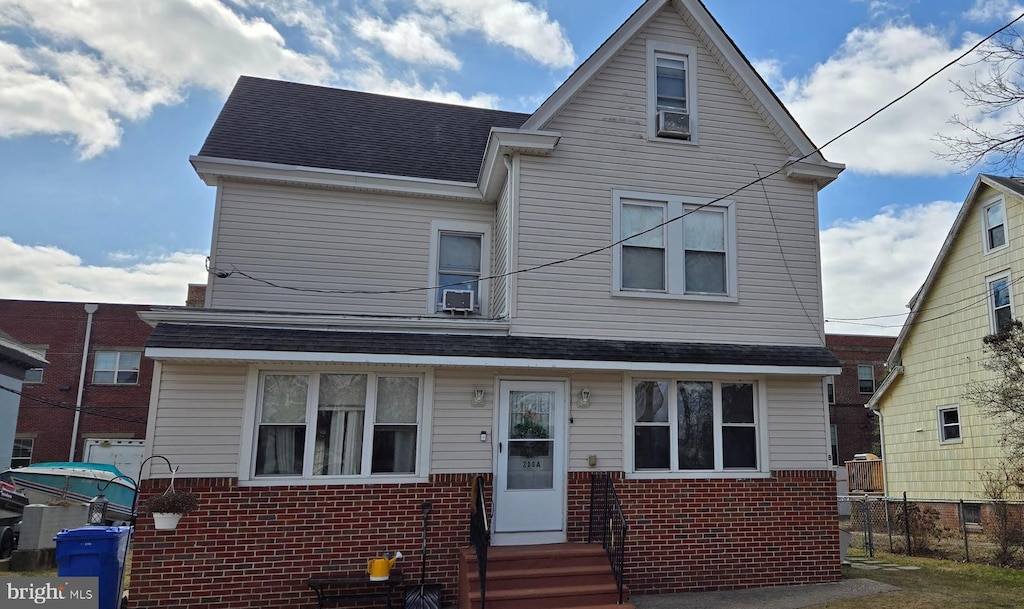 230 W Front St, Florence, NJ 08518 - traditional-style home with entry steps, roof with shingles, fence, and brick siding