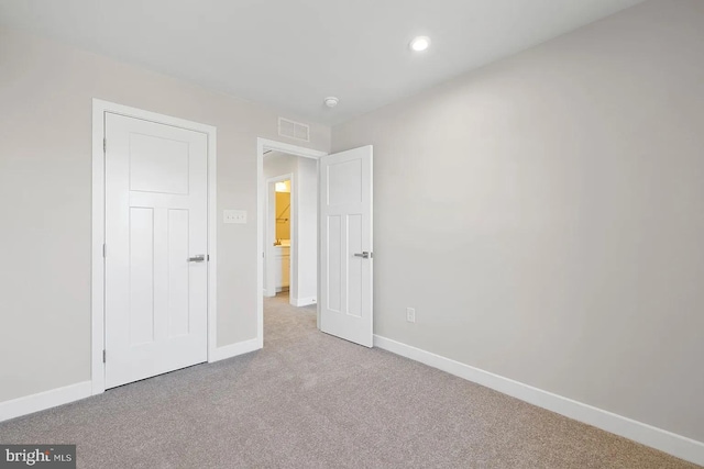 unfurnished bedroom featuring carpet, visible vents, and baseboards