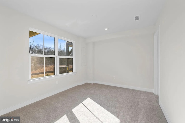 empty room featuring recessed lighting, visible vents, carpet flooring, and baseboards