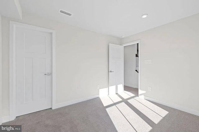 unfurnished bedroom with baseboards, visible vents, and carpet floors