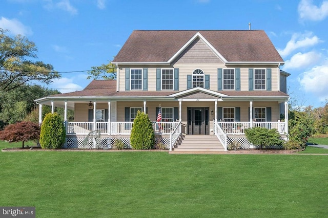 colonial house featuring a porch, a shingled roof, and a front lawn