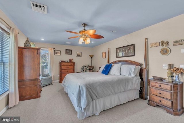 bedroom with visible vents, ceiling fan, light carpet, and baseboards