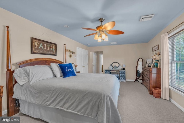 bedroom with ceiling fan, carpet flooring, visible vents, and baseboards