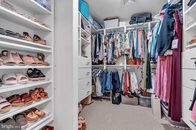 walk in closet with carpet flooring