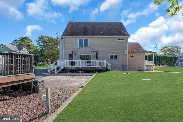 back of property with crawl space, a deck, a patio, and a yard