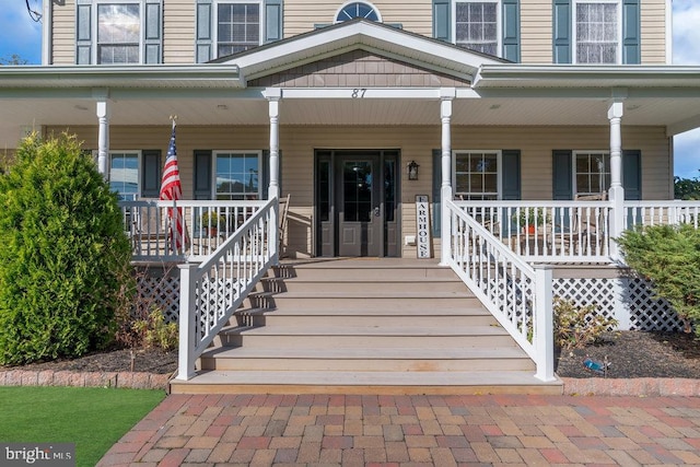 doorway to property featuring covered porch