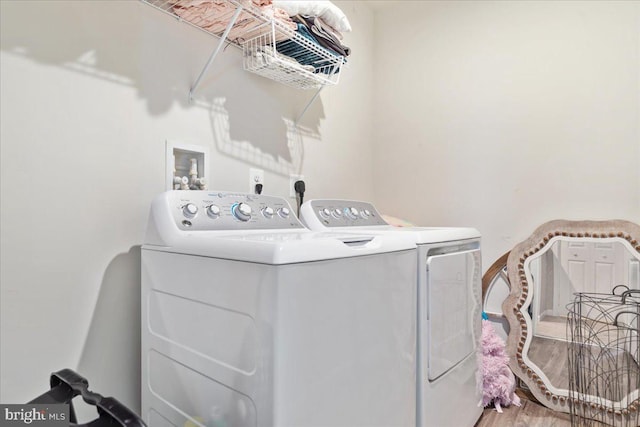 washroom featuring laundry area, independent washer and dryer, and wood finished floors