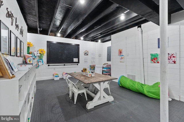 interior space with dark colored carpet, electric panel, and visible vents