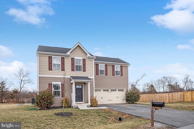 traditional home featuring an attached garage, fence, cooling unit, driveway, and a front lawn