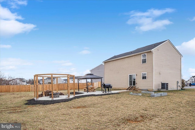 back of house with an outdoor fire pit, a gazebo, fence, a yard, and a patio area