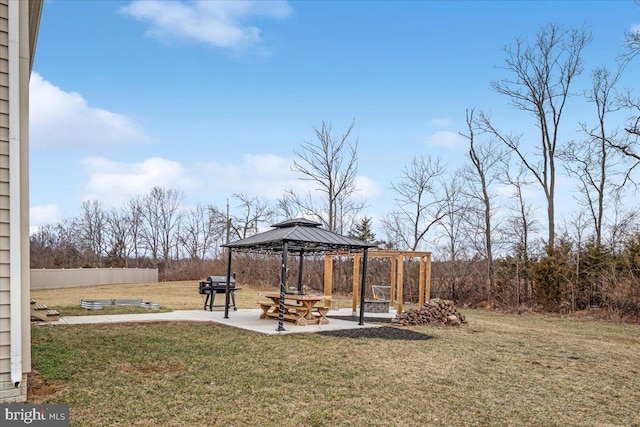 view of yard featuring a patio area, fence, and a gazebo