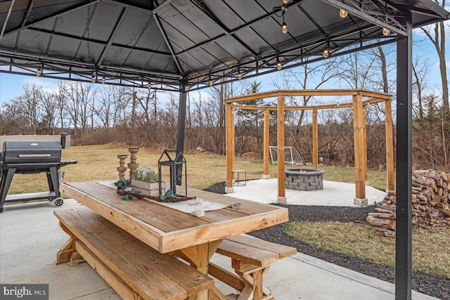 view of patio with a fire pit, a gazebo, outdoor dining area, and area for grilling