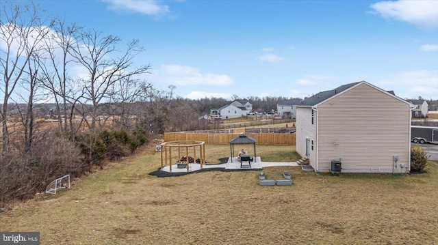 view of yard with a patio, central AC, and fence