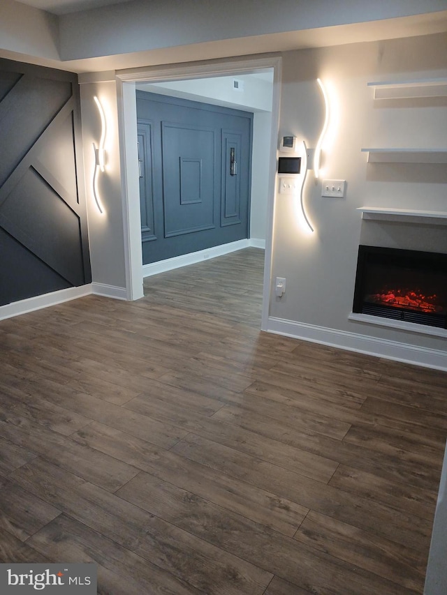 interior space featuring dark wood finished floors and baseboards