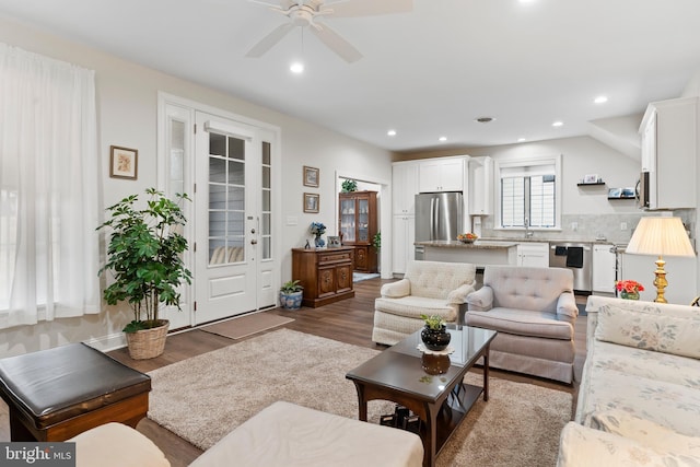 living area featuring a ceiling fan, wood finished floors, and recessed lighting