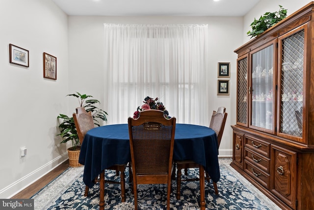 dining room featuring wood finished floors and baseboards