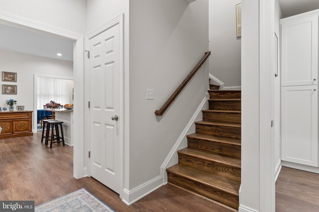 stairs with baseboards and wood finished floors