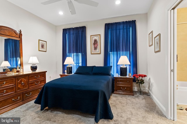 carpeted bedroom featuring recessed lighting, ceiling fan, baseboards, and ensuite bathroom