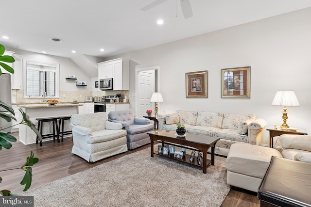 living room featuring recessed lighting, visible vents, dark wood finished floors, and ceiling fan