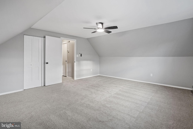 bonus room with ceiling fan, carpet, baseboards, and vaulted ceiling