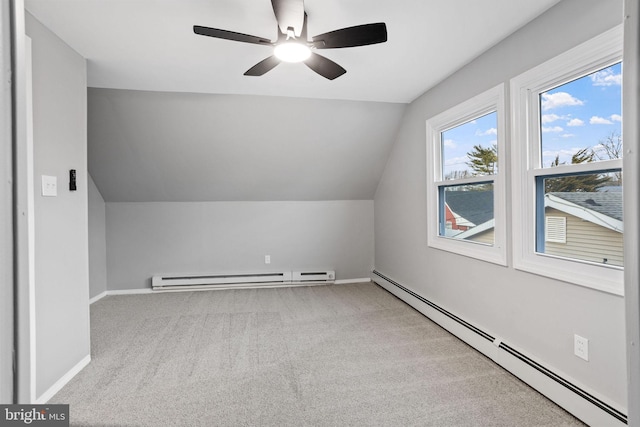 additional living space featuring a baseboard heating unit, baseboard heating, carpet flooring, and lofted ceiling